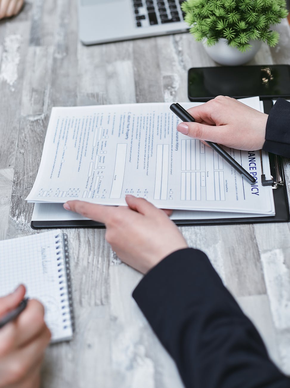 Insurance professional reviewing policy documents at organized desk