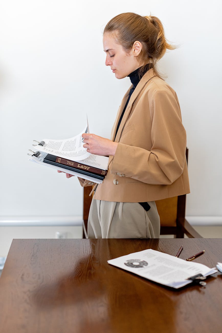 Legal assistant organizing case files at modern law office workstation