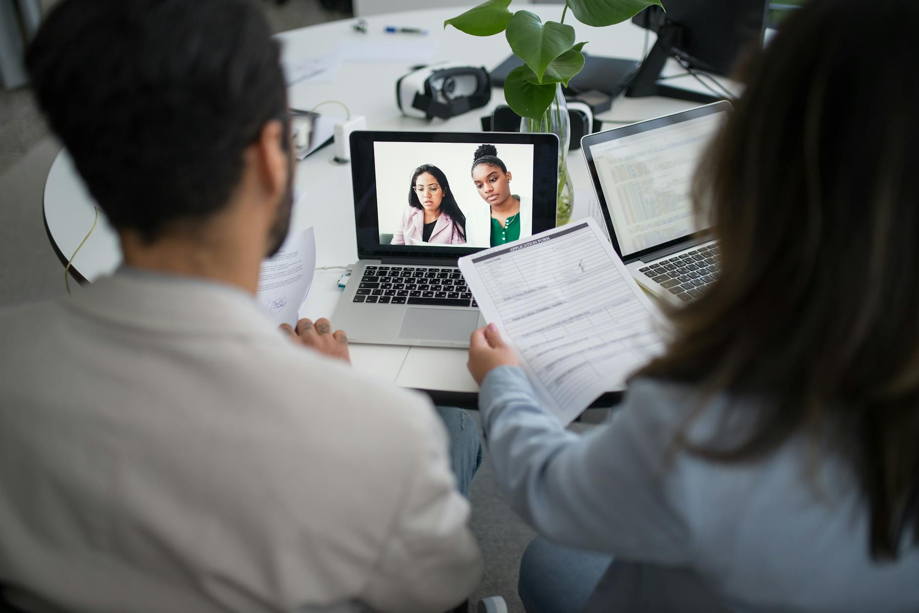 Recruiter conducting video interview with Latin American professional on laptop screen