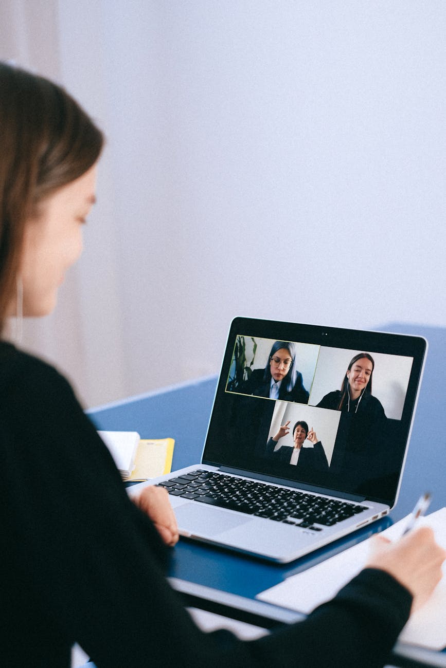 Remote team video call on laptop screen with diverse Latin American professionals smiling