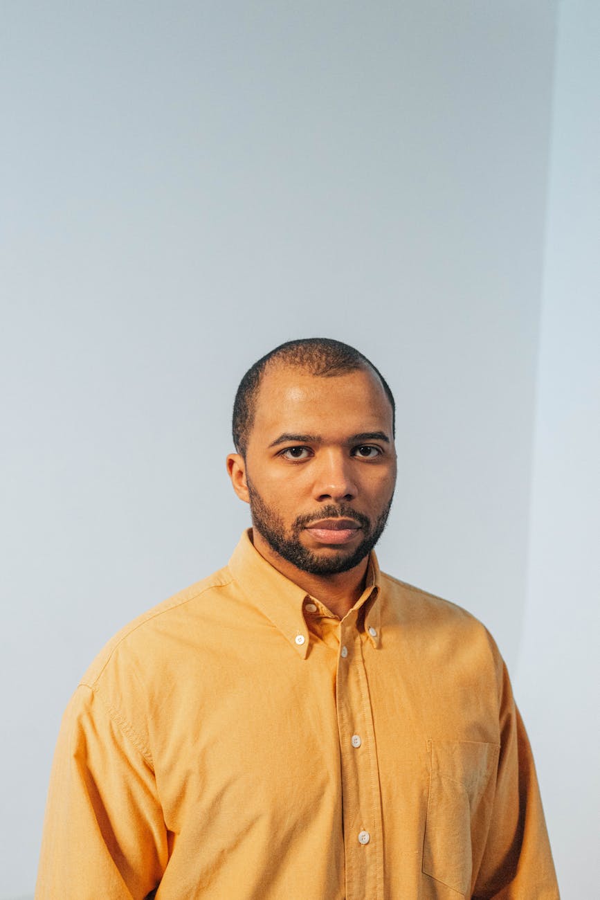 Professional Latino man in button-down shirt headshot neutral background